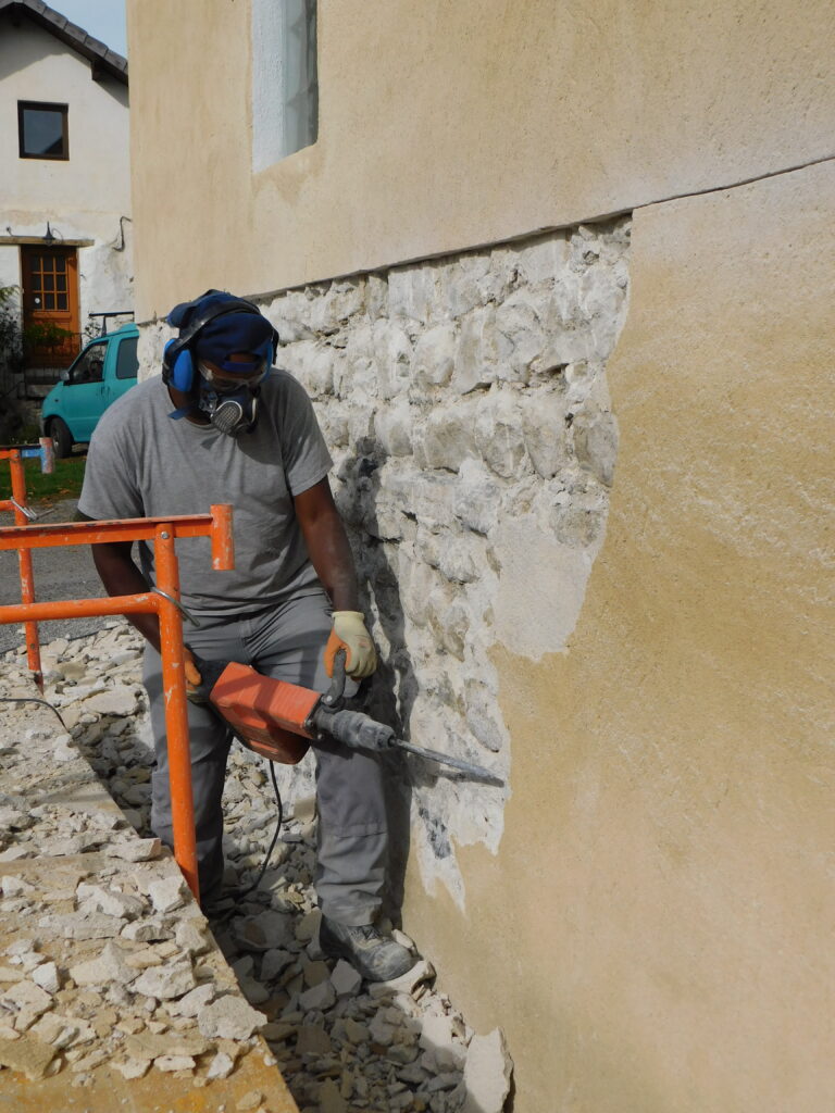 Préparation du mur : décroûtage, purge des joints et des éléments incohérents, et soufflage